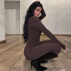 Slim fit dark brown ribbed knit long sleeve bodysuit showing side profile on a model
