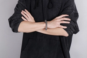 Detail of vintage punk skull bracelet in titanium steel worn on a male model's wrist