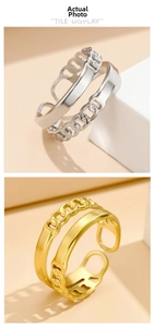 Close-up of double-layered stainless steel rings in gold and silver with chain link detail