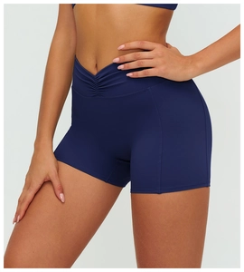 Detail of high waisted navy blue yoga shorts with V-cross waistband and ruching effect