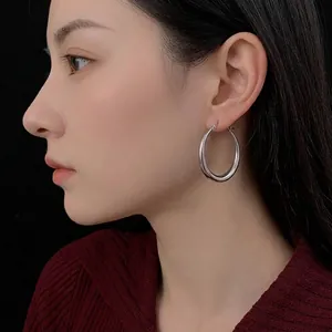 Polished silver hoop earrings for women featuring a minimalist large circular design