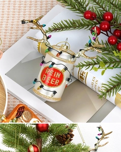 Detail of silver Reinbeer can ornament with gold reindeer antlers on a Christmas tree