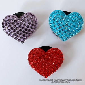Detail of three diamond heart phone grips in purple, blue and red on white background