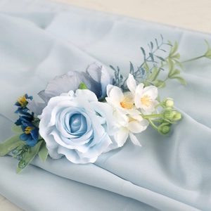 Elegant light blue silk rose corsage with white floral accents for wedding guests