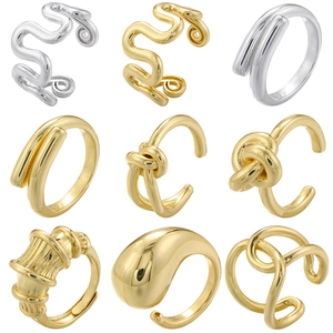Detailed grid view of minimalist gold and silver teardrop rings with twisted metal designs
