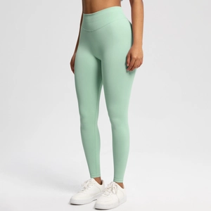Detail of mint green high-waisted seamless leggings with ribbed knit fabric texture