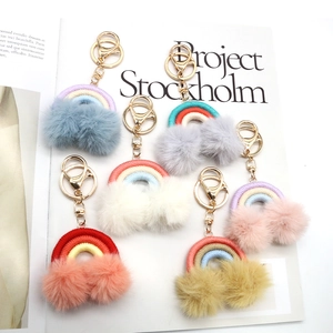 Handmade bohemian rainbow keychain with colorful tassels and soft plush pom poms