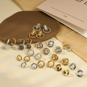 Detailed close-up of mixed stainless steel earrings featuring zircon and geometric shapes