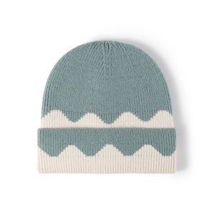Thick knitted beanie with green and cream wave pattern and fold-over cuff design