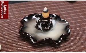 Macro detail of dark brown lotus ceramic backflow incense burner with smoke waterfall effect