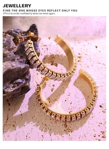Detail of 18K gold plated C-shaped earrings with micro-set rectangular zircons