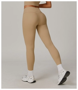 Detail of high waisted compression leggings in khaki with peach lift seam design