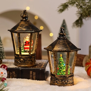 Close-up of vintage Christmas lantern ornaments with Santa and tree inside on snow