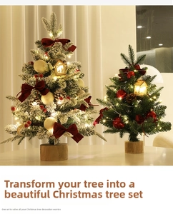 Detail of mini flocked Christmas tree with red velvet bows and LED lights on wood base