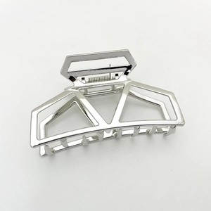 Close-up of silver geometric metal hair claw clip with hollow square design on white background