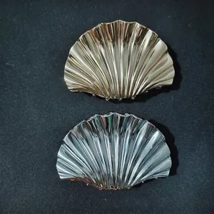 Chic gold and silver seashell hair claws with 3D texture for elegant hair styling