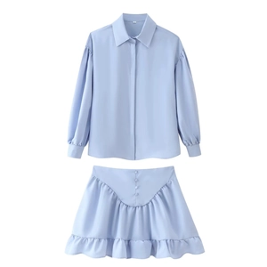 Flat lay of light blue long-sleeved shirt and ruffled mini skirt two-piece set in size S