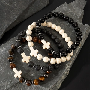 Stack of 4 men's beaded bracelets with obsidian, tiger eye, and white cross pendants