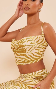 Detailed view of olive zebra print plissé fabric texture on the two-piece crop top set
