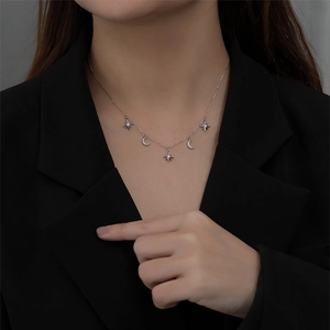 Elegant 925 sterling silver star and moon pendant necklace on a professional model