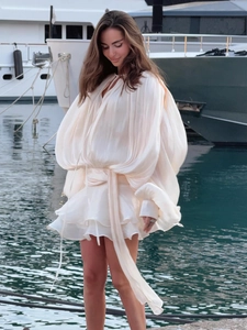 Detailed view of white chiffon mini dress featuring layered ruffles and lantern sleeves