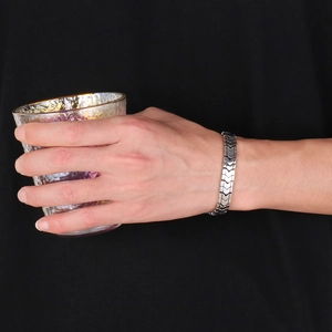 Men's stainless steel V-shaped curb chain bracelet shown on wrist with a sleek silver finish