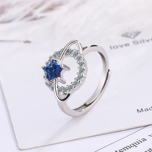 Adjustable silver star ring with blue center stone and zircon planet orbit design