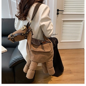 Brown donkey-shaped plush crossbody bag worn with a white blazer for a trendy look