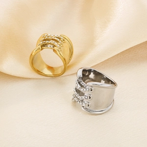 Close-up of gold and silver crossover lace-up rings with inlaid diamonds on silk