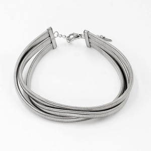 Detailed view of silver triple-layered snake chain choker with lobster clasp and extender