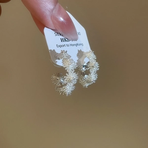 Macro detail of S925 sterling silver flower cluster earrings with textured finish