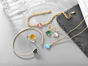 Detailed close-up of bohemian gold jewelry set with colorful round natural stones