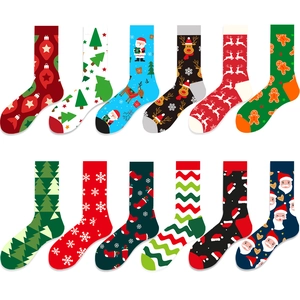 Flat lay of 12 festive Christmas cotton socks featuring Santa, reindeer and tree patterns
