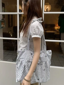Minimalist checkered tote bag with black bow embroidery and lightweight striped fabric