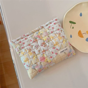 Detailed view of floral quilted cotton makeup bag featuring pink and yellow flowers