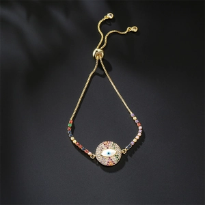 Macro shot of gold evil eye bracelet with colorful cubic zirconia and adjustable slide clasp