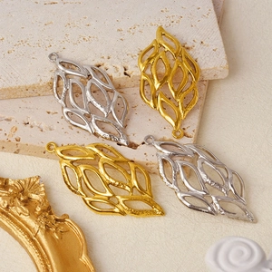 Macro shot of 304 stainless steel hollow leaf pendants in gold and silver finishes