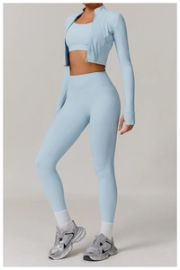 Three-piece light blue yoga set with zipper jacket, sports bra, and high-waist leggings