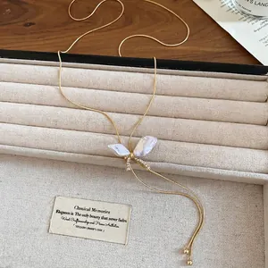 Elegant butterfly pendant necklace with mother-of-pearl and gold chain in a jewelry box