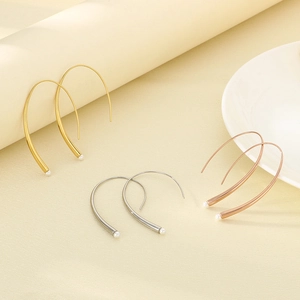 Minimalist curved wire earrings in gold, silver and rose gold with small pearl charms