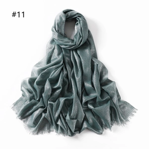 Detail of dark blue-grey scarf with metallic gold thread and delicate fringe edges