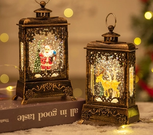 Detail of vintage bronze Christmas lanterns with Santa and reindeer inside swirling glitter