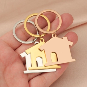 Three hollow house keychains in gold, silver, and rose gold stainless steel finishes