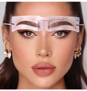 Detail view of eyebrow stencil with scale and elastic strap for hands-free shaping