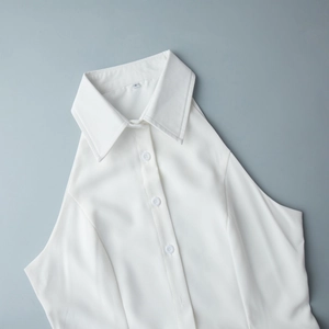 Detail of white sleeveless shirt with classic collar, buttons and visible S size tag