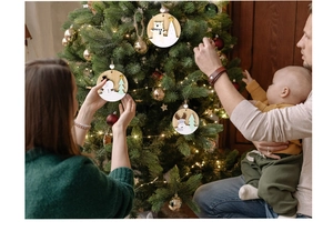 Close-up of laser-cut wooden Christmas ornaments with snowman and elk designs