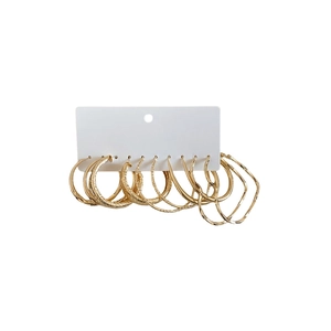 Golden resin hoop earrings set on white card display with minimalist circular designs