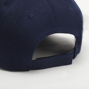 Detail of navy blue cotton baseball cap featuring adjustable velcro strap and premium stitching