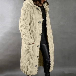 Detail of chunky cable knit texture on beige long hooded cardigan with large buttons
