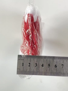 Detailed size measurement of 70mm mini plush Christmas hat ornament with metal ruler